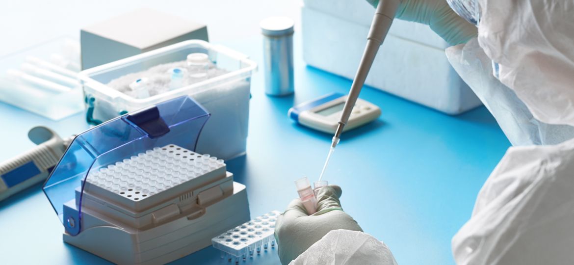 SARS-COV-2 pcr diagnostics kit. Epidemiologist in protective suit, mask and glasses works with patient swabs to detect specific region of 2019-nCoV virus causing Covid-19 viral pneumonia.