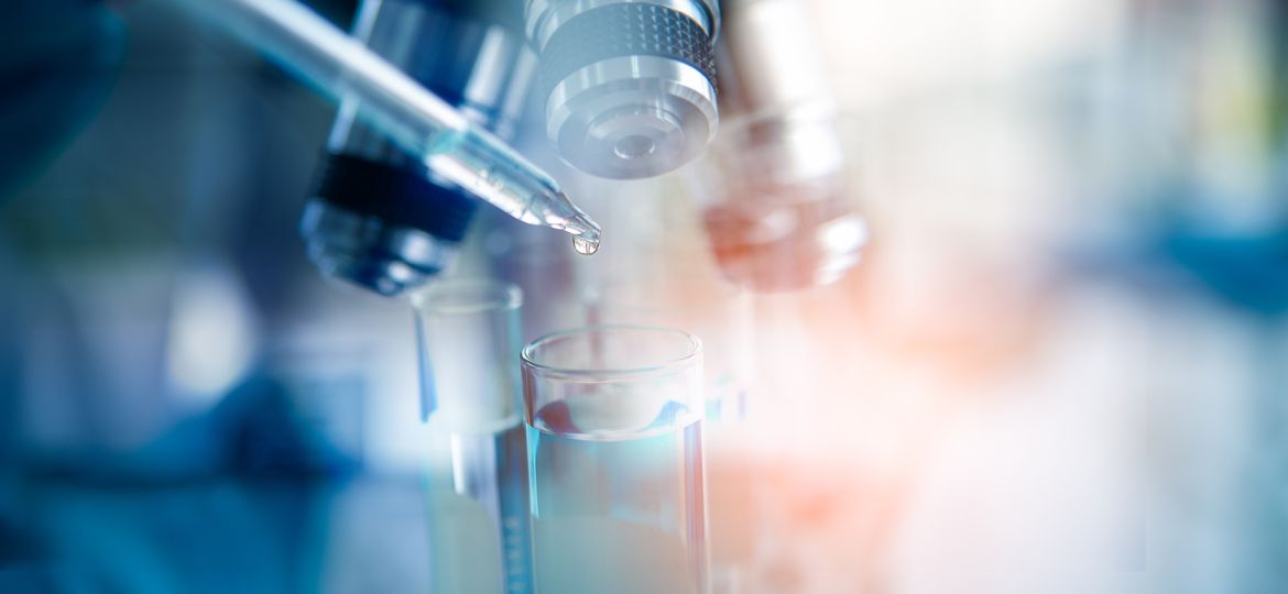 Test tubes closeup on blue background. Microscope with lab glassware, science laboratory research and pharmaceutical