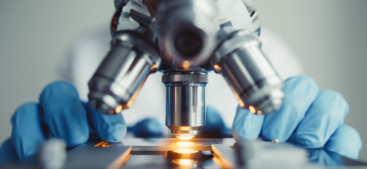 Close up of examining of test sample under the microscope