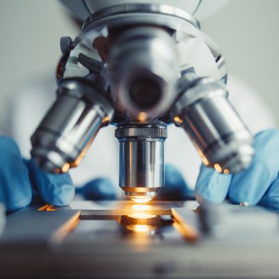 Close up of examining of test sample under the microscope