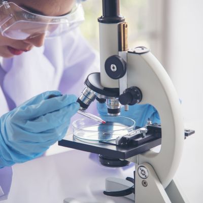 Woman scientist in lab look at science microscope medical test and research biology chemistry. Females technician laboratory analyzing scientific pharmacy genetic research. Chemistry Medical test lab