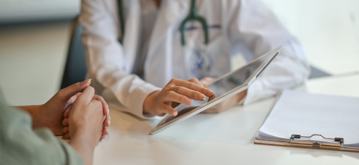 Shot of a doctor showing a patient some information on a digital tablet