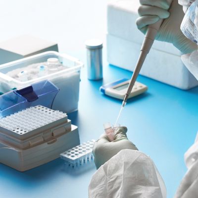 SARS-COV-2 pcr diagnostics kit. Epidemiologist in protective suit, mask and glasses works with patient swabs to detect specific region of 2019-nCoV virus causing Covid-19 viral pneumonia.